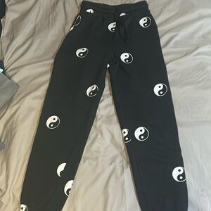 Black sweatpants with Ying-yang prints.